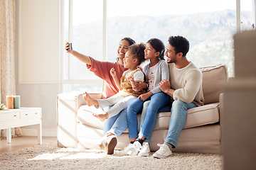 Image showing Parents, children and couch selfie with smile, happiness and bond in lounge for social media app. Father, mother and daughters with care, love and together for profile picture, blog and happy on sofa