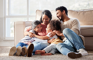 Image showing Love, home and family on the floor, smile and bonding with affection, peaceful and loving together. Parents, mother or father with female children, kids or girl on the ground, lounge or weekend break