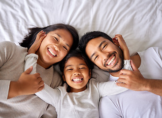 Image showing Love, selfie and family in bed from above happy, smile and bonding in their home together. Portrait, girl child and top view of parents with their daughter in a bedroom, relax and embracing indoors