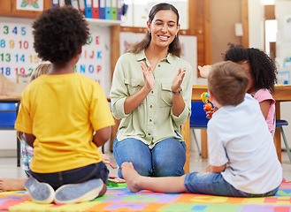 Image showing Diversity, teacher with children at school and playing together in a classroom at. Teaching or learning, education or collaboration and happy female person with preschool kids play on floor in class