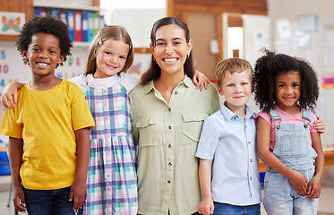 Image showing Education, portrait of teacher with children and in a classroom of a school. Diversity or support, happiness or caring and smiling female person with kids at kindergarten in a class together.