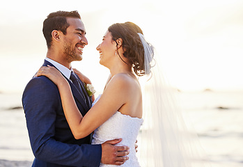 Image showing Wedding day, beach and couple hug at ocean for love, union and celebration on nature background. Summer, marriage and happy groom with bride embracing at sea ceremony, smile and romantic in Hawaii