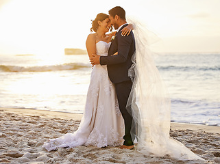 Image showing Beach, wedding and couple hug at ocean for love, union and celebration against a nature background. Summer, marriage and happy groom with bride embracing at sea ceremony, smile and romantic in Bali