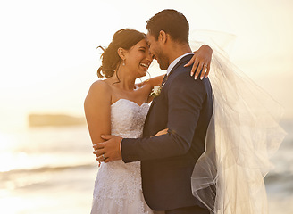 Image showing Wedding, beach and couple hug at sunset for love, union and celebration against a nature background. Summer, marriage and happy groom with bride embracing at sea ceremony, smile and romantic in Miami