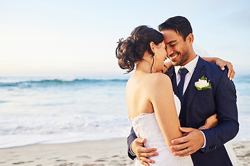 Image showing Wedding day, hug and couple at a beach for love, union and celebration against a nature background. Summer, marriage and happy groom with bride embracing at sea ceremony, smile and romantic in Bali