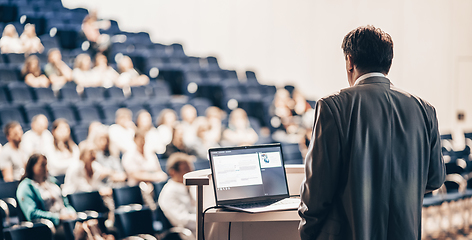 Image showing Speaker giving a talk on corporate business conference. Unrecognizable people in audience at conference hall. Business and Entrepreneurship event.