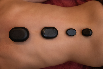 Image showing therapy with hot stones in spa center