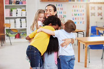 Image showing Care, teacher with school children hug and in a classroom with a lens flare. Support or love, happiness or teaching and happy or cheerful woman with kindergarten kids hugging together in a class