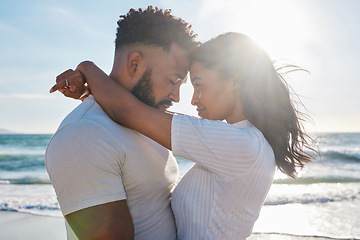 Image showing Couple hug at beach, love and travel with sun and sea, affection and care with vacation in Mexico. Commitment, support and trust with relationship, tourism and tropical with people in embrace outdoor