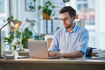 Image showing Laptop, typing and business man, IT and working on web project in office at night. Focus, computer and male professional, programmer and coder writing email, programming website or research deadline.