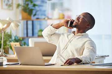 Image showing Happy African business man, phone call and laugh with contact, comic conversation and talking at desk. Young black businessman, communication expert or crm with smartphone, happiness and connectivity