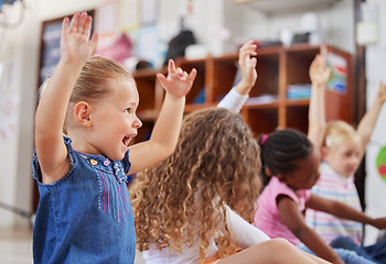 Image showing School, raise hands and children in a classroom for education or knowledge at daycare. Kindergarten, happy and young kid students with a question gesture for learning in a lesson together at nursery.