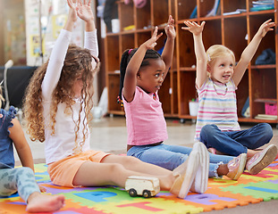 Image showing Education, raise hands and children in kindergarten in a classroom for education or knowledge. Daycare, happy and young kid students with a question gesture for learning in lesson together at nursery