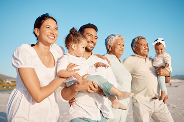 Image showing Happy, big family and relax on beach for holiday, weekend or fun vacation together in the nature outdoors. Grandparents, parents and kids with smile on ocean coast for travel or bonding in happiness