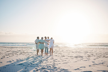 Image showing Big family, hug and walking on beach with mockup space for holiday, weekend or vacation. Grandparents, parents and kids on a ocean walk together by the coast for fun bonding or quality time in nature