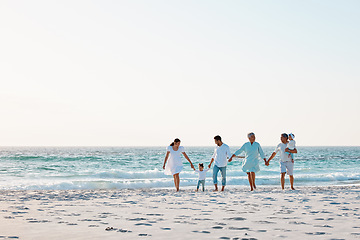 Image showing Big family, holding hands and walking on beach with mockup space for holiday weekend or vacation. Grandparents, parents and kids on a ocean walk together for fun bonding or quality time in nature