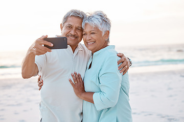 Image showing Senior couple, hug and beach for selfie, profile picture or online post together in nature. Happy elderly man and woman smiling on ocean coast for photo, memory or social media vlog in the outdoors