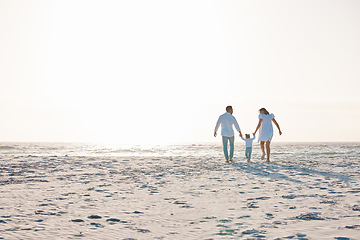 Image showing Family, holding hands and walking on beach with mockup space for holiday weekend or vacation. Mother, father and child on a ocean walk together for fun bonding, travel or quality time in nature