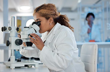 Image showing Science, development and microscope with a woman at work in a laboratory for research or innovation. Healthcare, medical and investigation with a female scientist working in a lab for pharmaceuticals