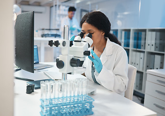 Image showing Science, investigation and microscope with a woman at work in a laboratory for research or innovation. Healthcare, medical and development with a female scientist working in a lab for pharmaceuticals