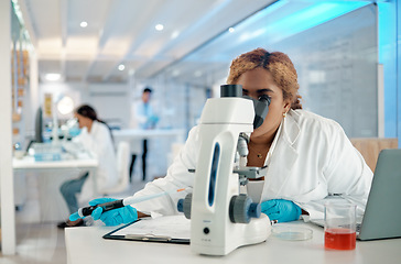 Image showing Science, medical and microscope with a woman at work in a laboratory for research or innovation. Healthcare, investigation and development with a female scientist working in a lab for pharmaceuticals