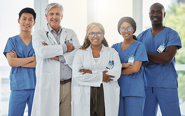 Image showing Leadership portrait, smile and doctors with arms crossed standing together in hospital. Face, teamwork and confident medical professionals, surgeon group and nurses with collaboration for healthcare.