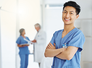 Image showing Portrait, nurse and Asian man with arms crossed in hospital or clinic for healthcare. Face, confidence and happy medical professional, surgeon and doctor with pride for career, job and wellness.