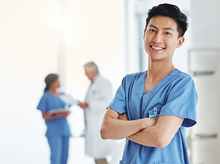 Image showing Portrait, happy man and Asian nurse with arms crossed in hospital or clinic. Face, confidence and medical professional, male surgeon or doctor with pride for career, job and healthcare for wellness.