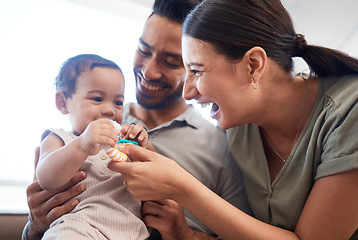 Image showing Happy family, baby and parents laughing, funny and excited for quality time, bonding and home development of child. Mother, father and girl or kid with dad, mom or people and toys, love and care