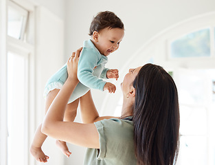 Image showing Mom carrying happy baby in home for love, care and quality time together to nurture childhood development. Mother, playing and holding infant kid for support, happiness and funny laughing in house