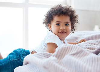 Image showing Portrait, toddler girl and smile in bedroom for happiness, childhood development and growth with curly hair. Cute, adorable and sweet young child, happy kid and relax in comfortable nursery at home