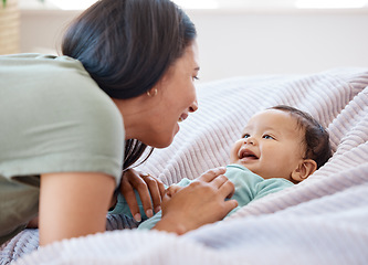 Image showing Mom, baby and laughing on bed in home for love, care and quality time together for play, growth and kids development. Happy mother, infant child and fun with newborn girl, relax and smile in bedroom