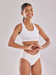 Image showing Woman in underwear, portrait with heart hands and gut health, self love and fitness on studio background. Gesture, emoji and diet, healthy digestion and happy female model with body and lose weight