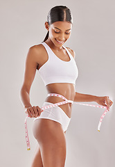 Image showing Happy woman in underwear, body and measuring tape, lose weight and health with diet isolated on studio background. Healthy lifestyle, detox and liposuction, female person check progress of weightloss