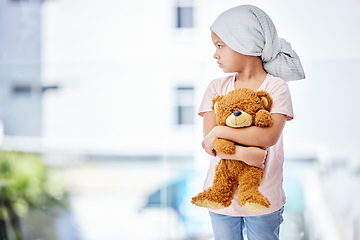 Image showing Healthcare, teddy bear and child cancer patient holding her toy for support or comfort. Medical, recovery and girl kid with leukemia standing after treatment or chemotherapy in a medicare hospital.