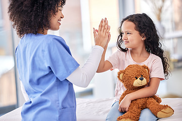 Image showing High five, nurse and child on bed in hospital for children, health and support in medical treatment. Pediatrics, healthcare and kid, nursing caregiver touching hands with young patient and teddy bear