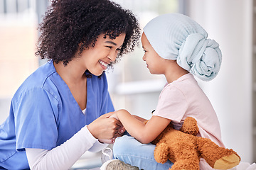 Image showing .Support, nurse and child holding hands on bed in hospital for children, health and smile at cancer treatment clinic. Pediatrics, healthcare and kids, nursing caregiver together with young patient.