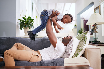 Image showing Black family, airplane and father with son on a sofa with love, lifting and playing in their home together. Flying, child and fun with parent on sofa, laugh and play, bonding and games in living room