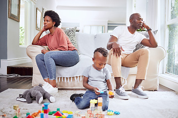 Image showing Family, fight and couple argue on a sofa, stress and divorce with playing child on a living room floor. Marriage, crisis and angry woman with man on couch after conflict, argument or problem with son