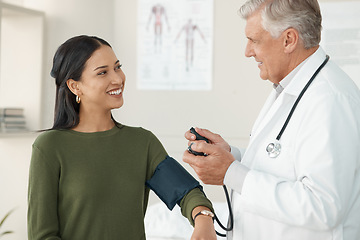 Image showing Senior doctor, blood pressure or patient in a consultation, wellness or appointment with results, checkup or talking. Healthcare, woman or medical physician with cuff for hypertension or examination