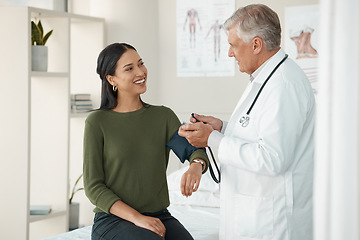 Image showing Senior doctor, blood pressure and patient in a consultation, healthcare and appointment with treatment, diagnosis and results. Wellness check, woman or medical professional with cuff for hypertension