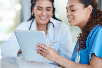 Image showing Hospital, doctors and women in discussion on tablet for medical analysis, research and internet. Healthcare, clinic and female health workers talking on digital tech for advice, consulting or service