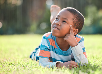 Image showing Nature park, black boy thinking and lying on grass outside at park with a lens flare. Day dreaming or think, decisions and young male person on field with ideas or contemplating outdoors on lawn