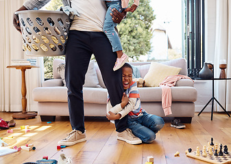 Image showing Tantrum, crying and boy on leg of father shouting with anger, frustrated and upset emotions at home. Family, discipline and child holding parent scream with mess, laundry and toys in living room