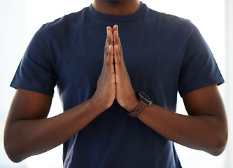 Image showing Hands, worship and man praying in studio in hope of help, guidance and gratitude in white background. Hand, pray and male person in prayer to Jesus Christ, humble and spiritual, holy and Christianity