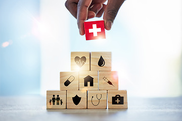 Image showing Hand, building blocks and man with cross, medical or icons for investment, security and insurance. Finger, choice and male with puzzle for healthcare, family or asset management, safety or planning