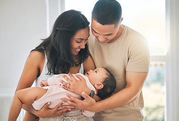 Image showing Mother, father and holding baby in a family home for bonding, security and quality time. Happy woman, man and girl child relax together in a house for development, trust and support or care and love