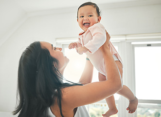 Image showing Mother, lifting baby and happy in a family home with love, fun and quality time. Woman or mom and child relax and laugh together in a house for development, trust and support or care on mothers day