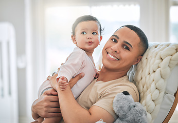 Image showing Father, holding baby and portrait in a family home for bonding, security and quality time. Man or dad and girl child relax together on a sofa for development, trust and support or care with a smile