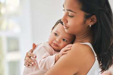 Image showing Mother, holding baby and love in a family home for bonding, security and quality time. Woman or mom and girl child relax together in a house for development, trust and support or care on mothers day